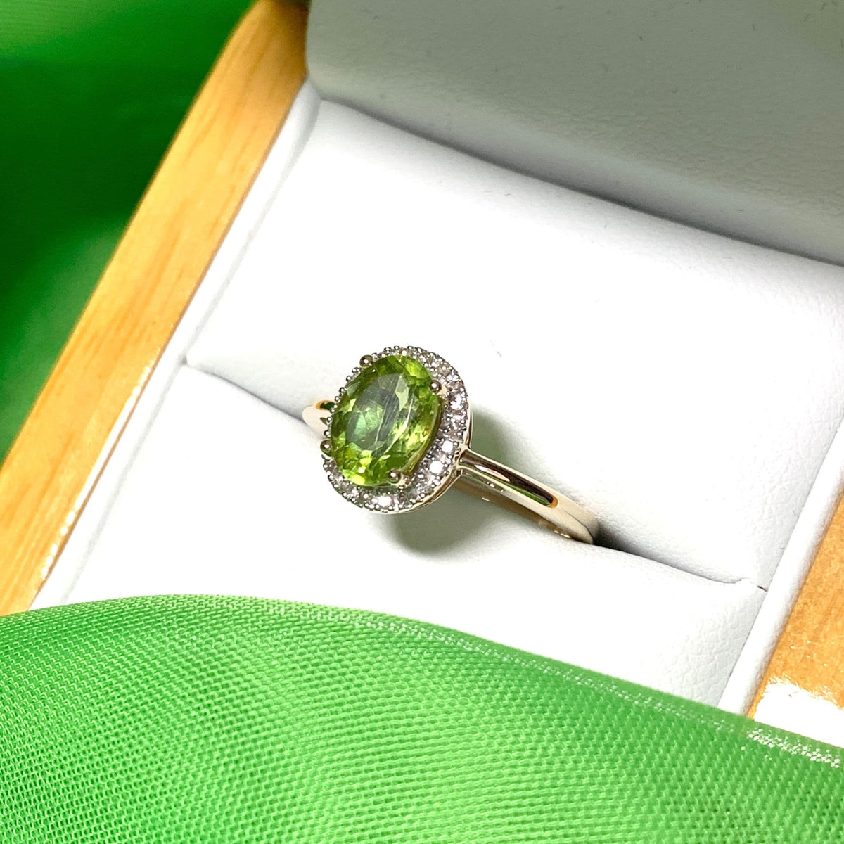 Peridot and diamond yellow gold oval cluster ring