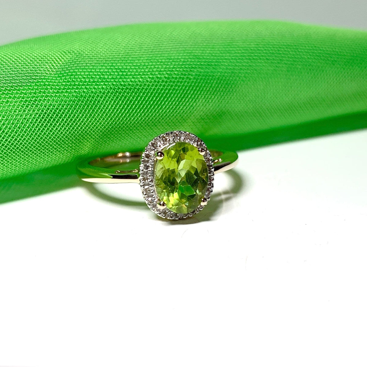 Peridot and diamond yellow gold oval cluster ring