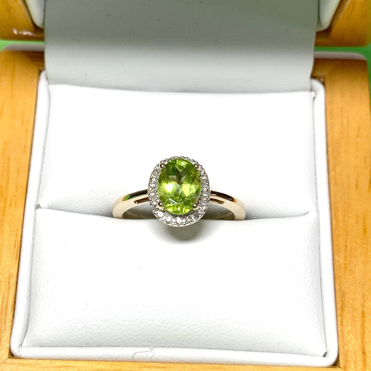 Peridot and diamond yellow gold oval cluster ring