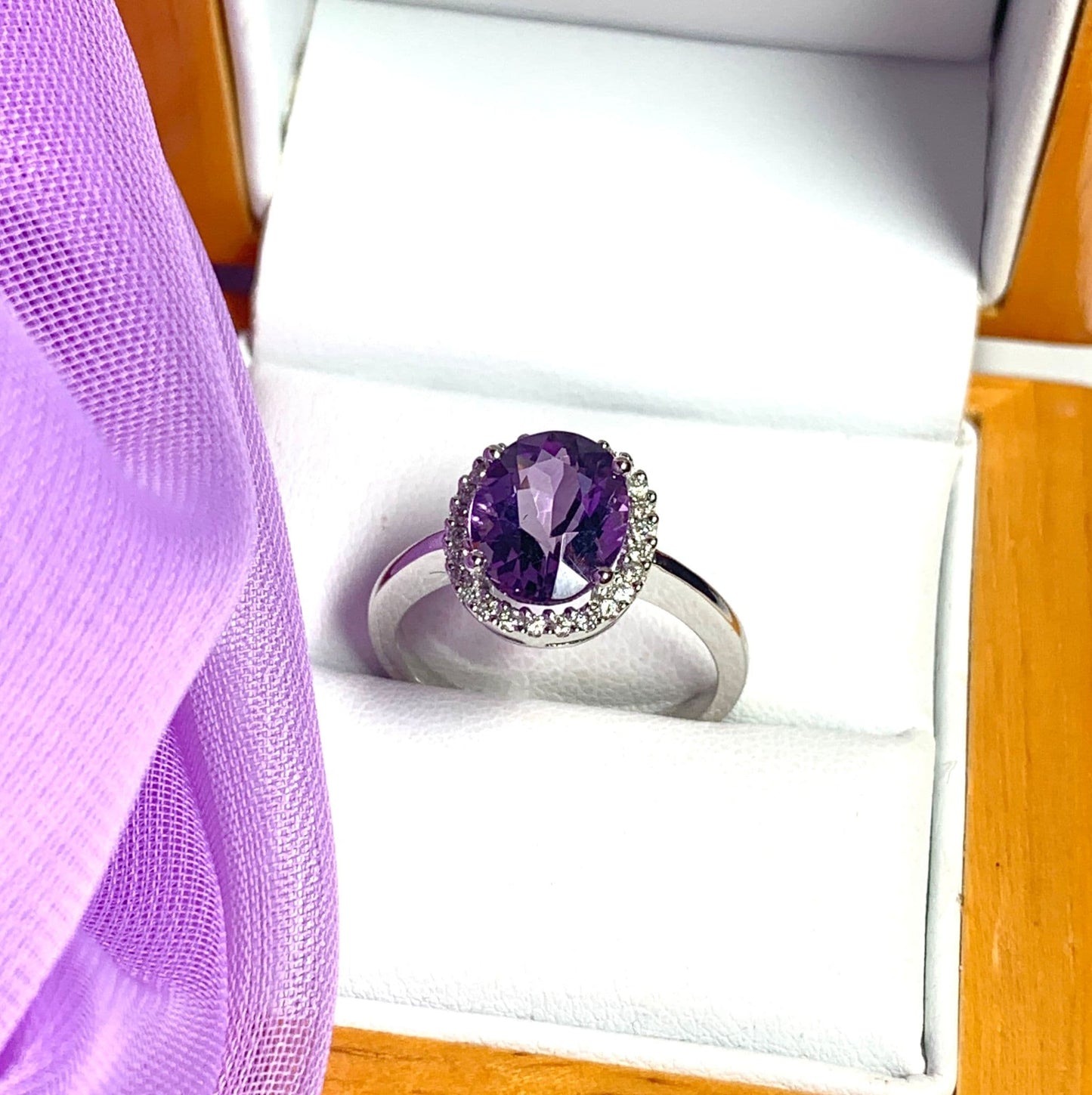 Purple oval amethyst and diamond white gold cluster ring