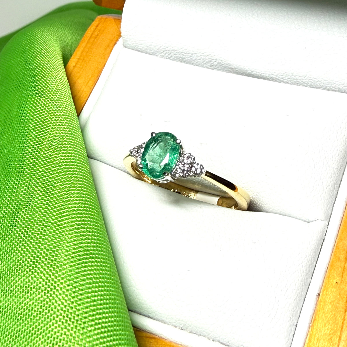 0.70 carat real green emerald and diamond 18 carat yellow gold oval trilogy dress ring