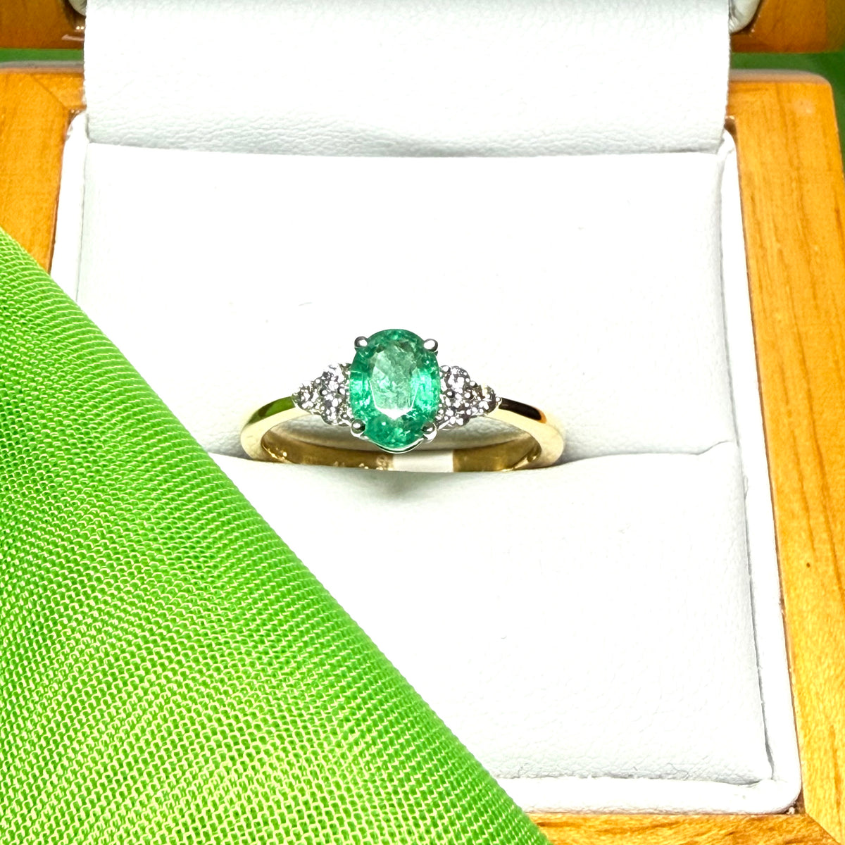 0.70 carat real green emerald and diamond 18 carat yellow gold oval trilogy dress ring