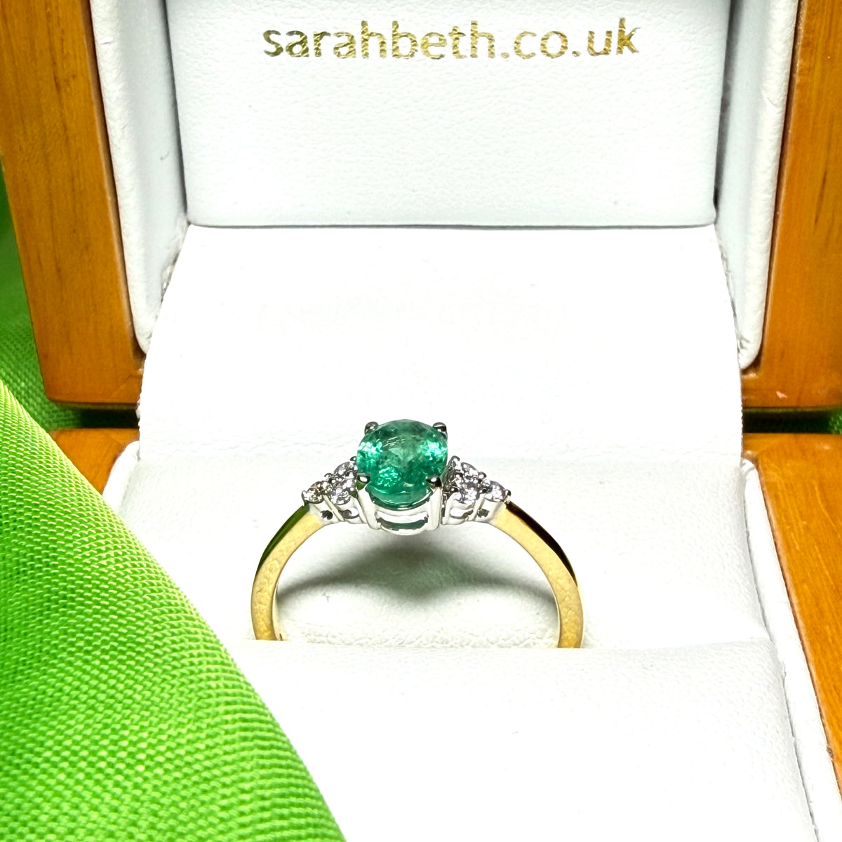 0.70 carat real green emerald and diamond 18 carat yellow gold oval trilogy dress ring