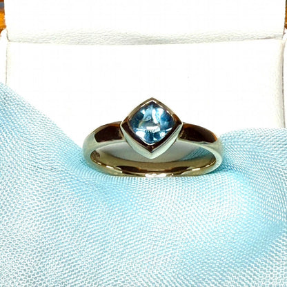 Blue topaz ladies dress ring yellow gold with a smooth rubbed over setting