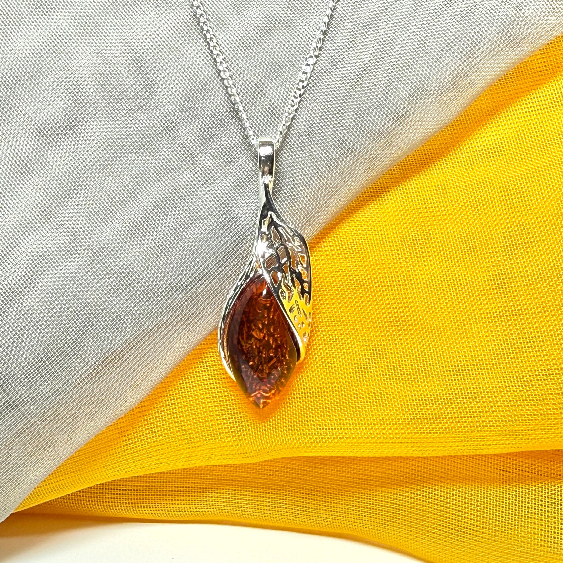 Real amber marquise sterling silver necklace with a swirl set fancy open pendant