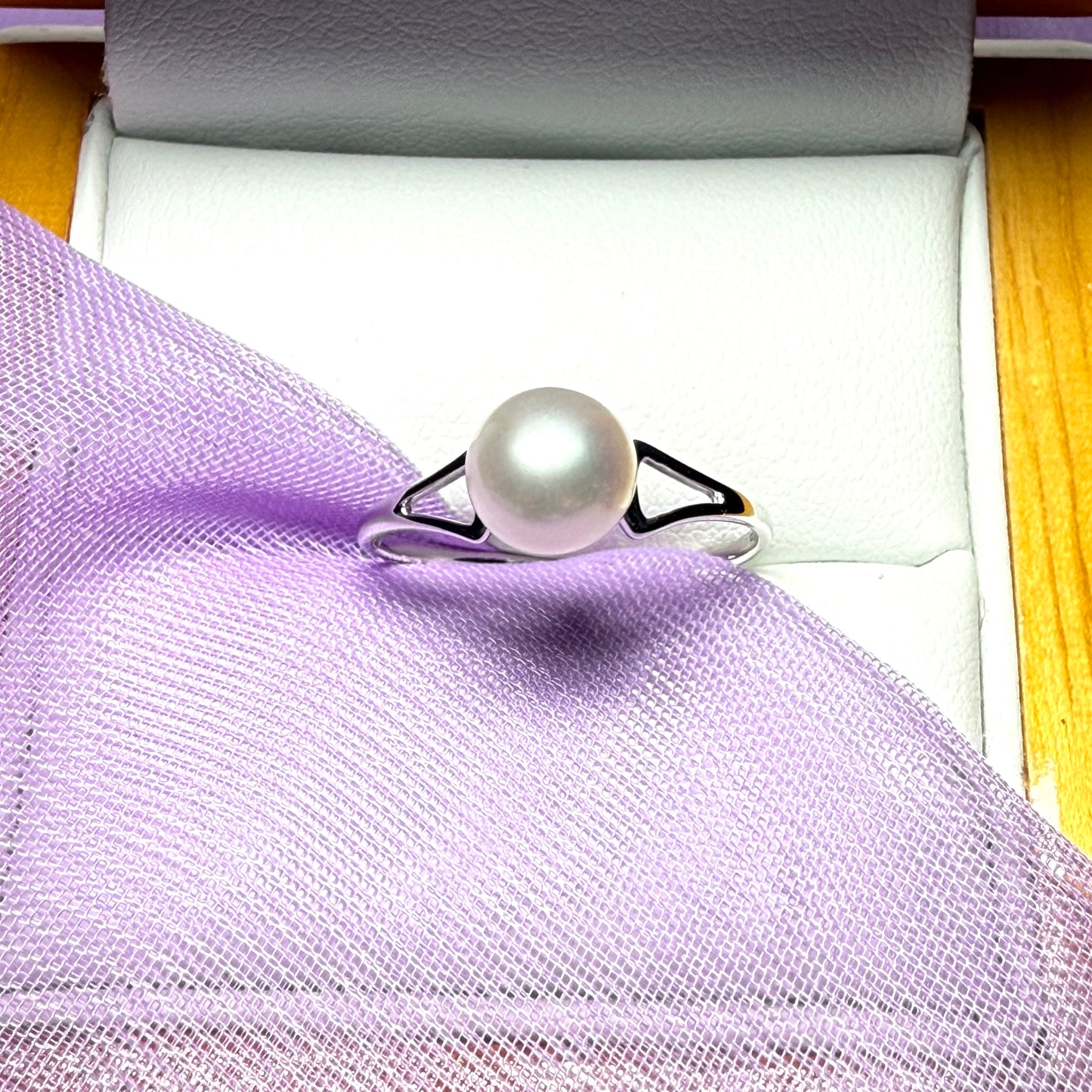Round real cultured single pearl ring with an open shoulder design white gold