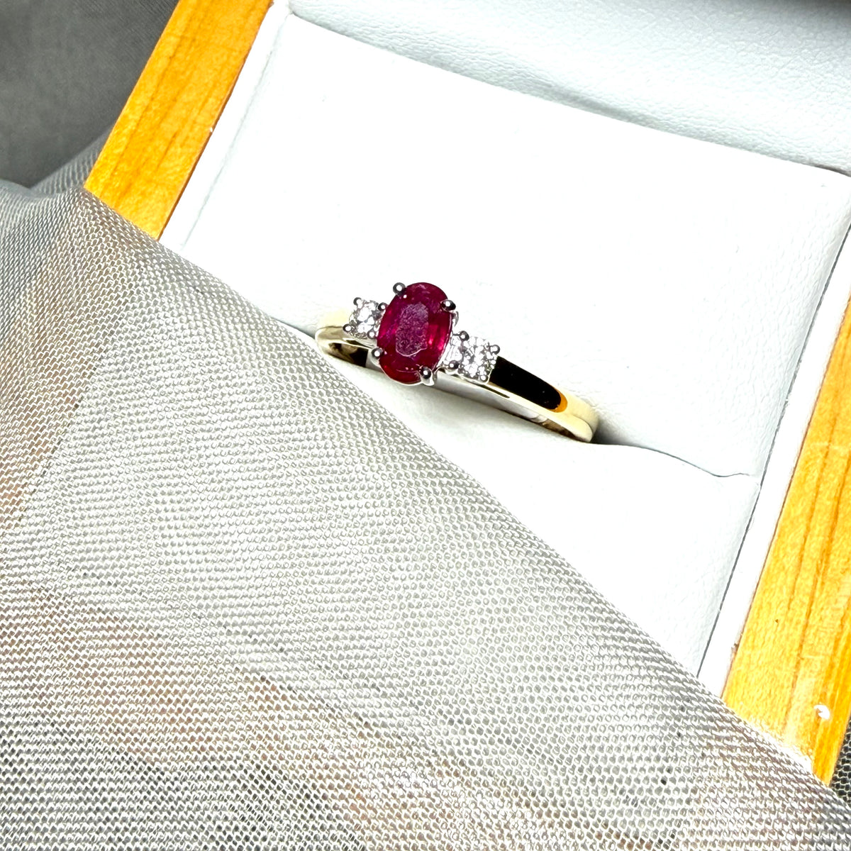 Ruby and diamond yellow gold three stone trilogy ring