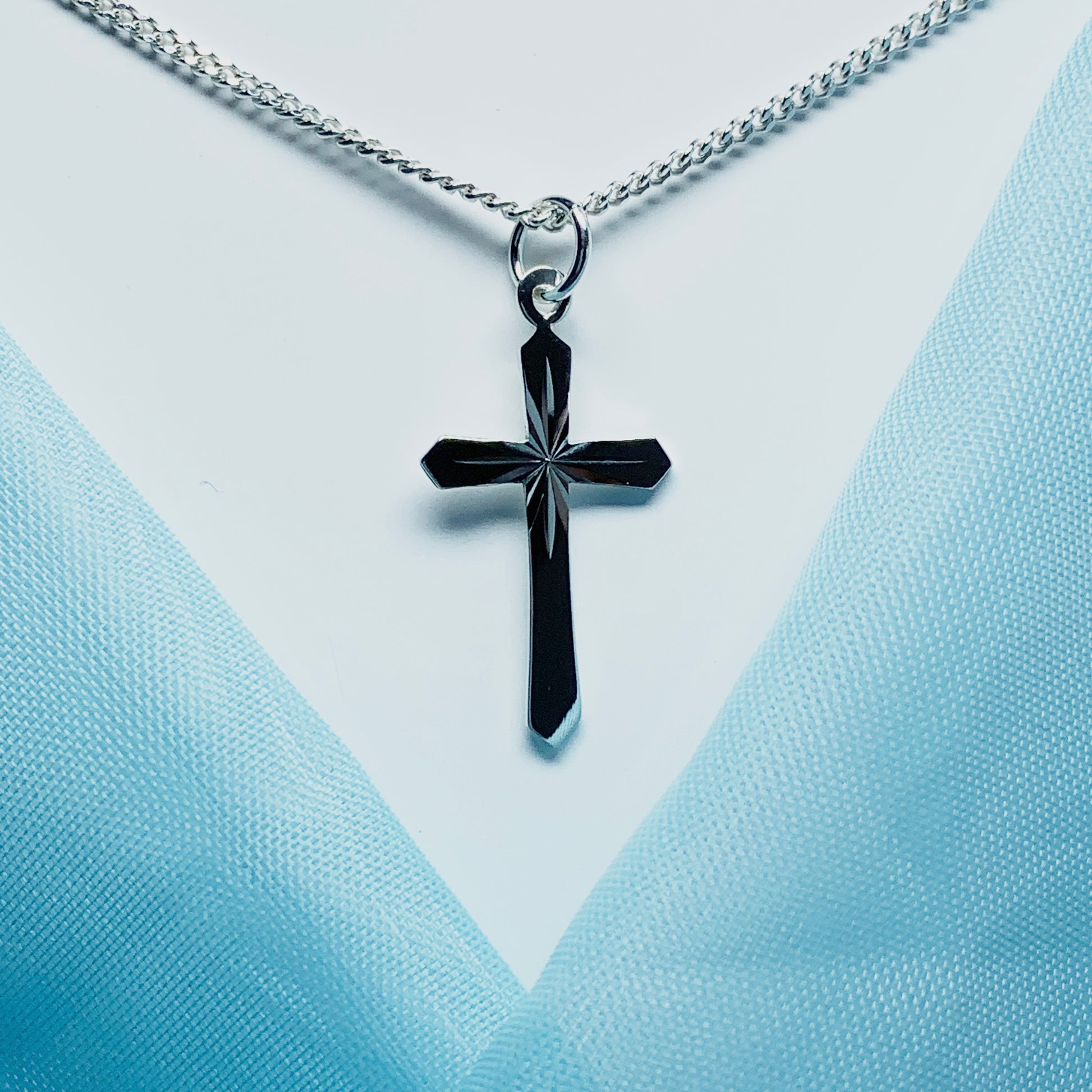 A Sterling silver diamond cut cross necklace including chain