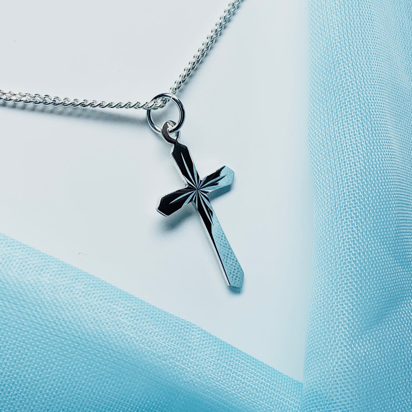 A Sterling silver diamond cut cross necklace including chain