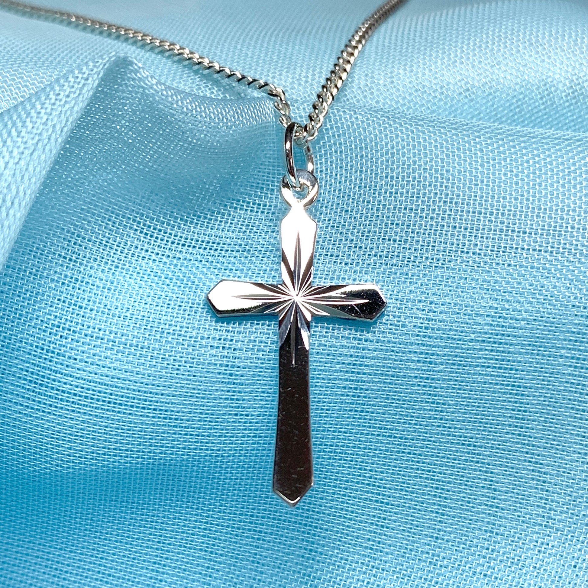 A Sterling silver diamond cut cross necklace including chain