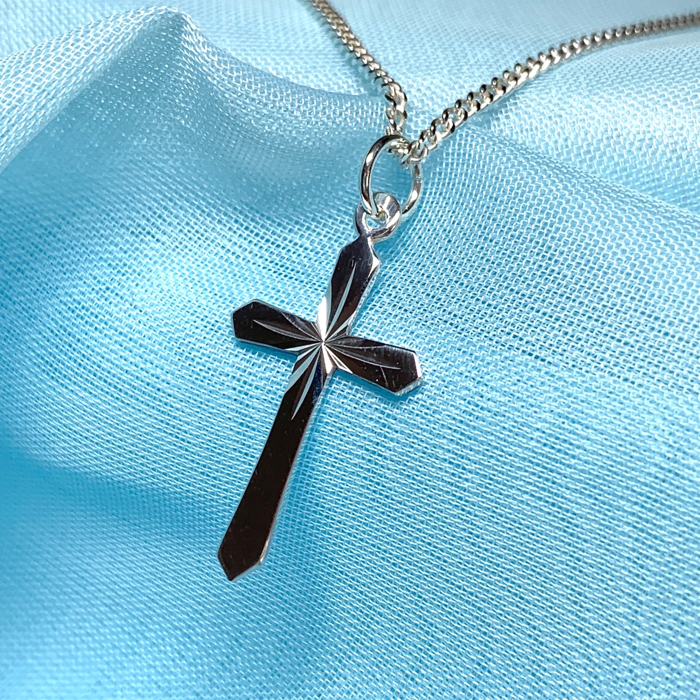A Sterling silver diamond cut cross necklace including chain
