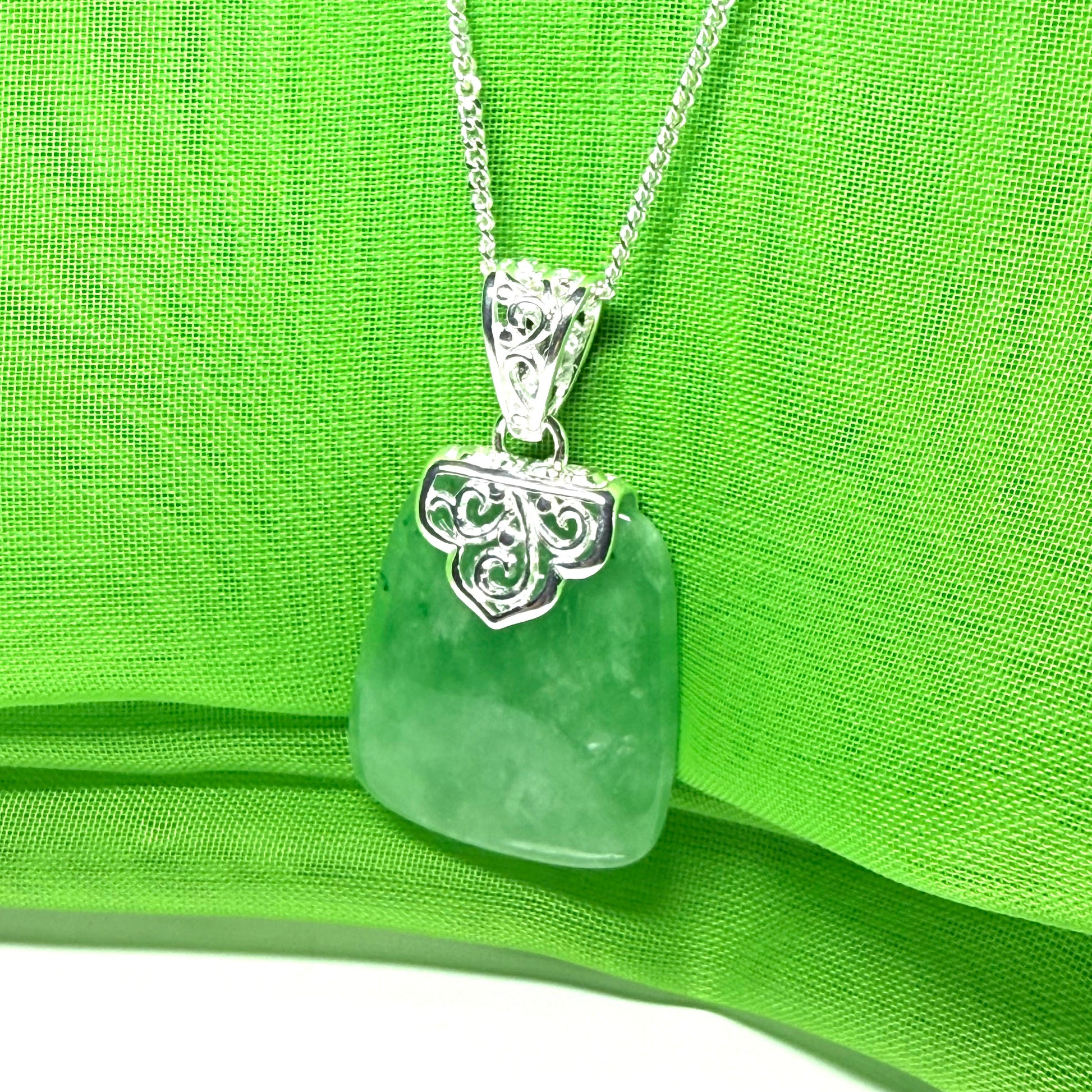 A beautiful and stunning real green jade necklace large pendant that is cushion shaped