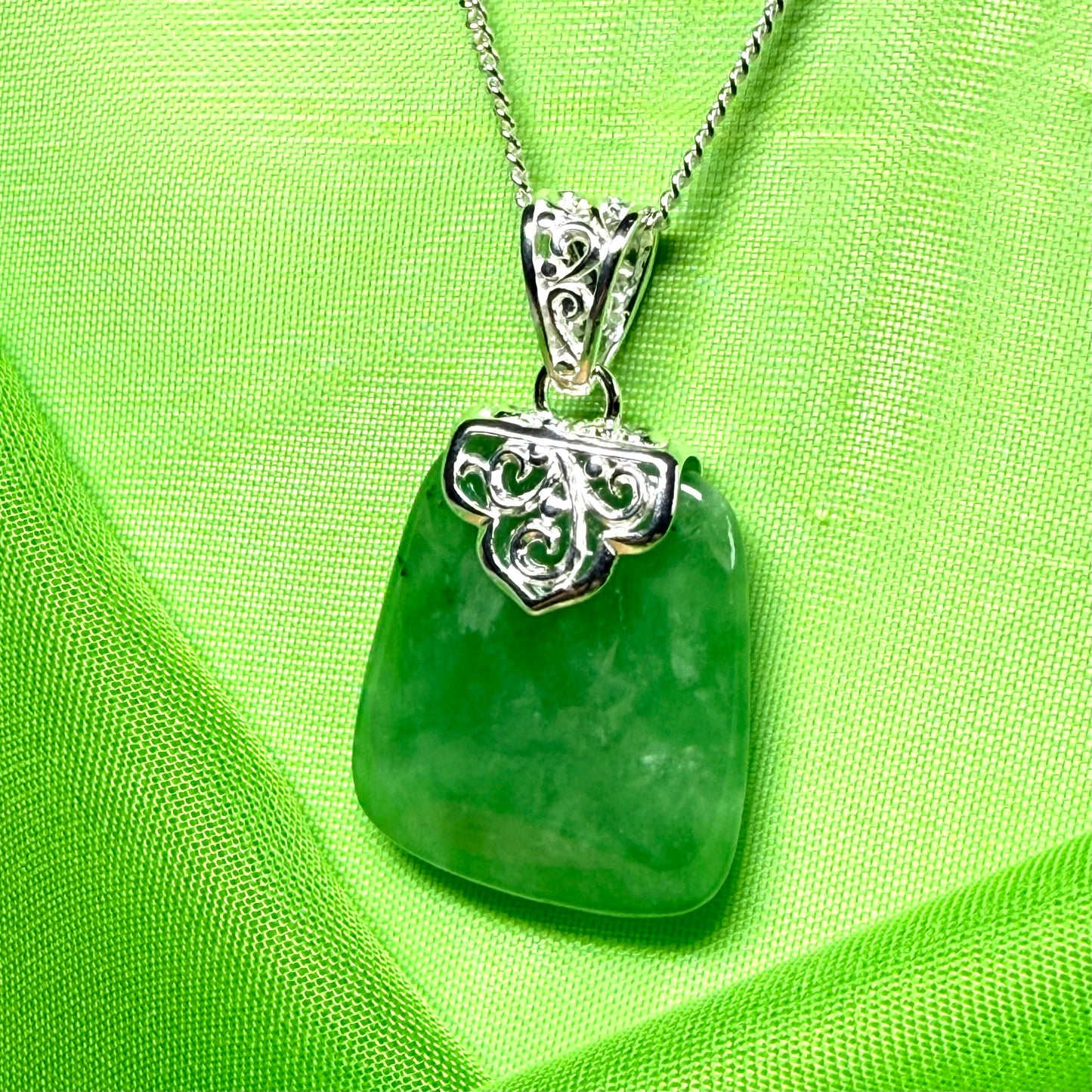 A beautiful and stunning real green jade necklace large pendant that is cushion shaped
