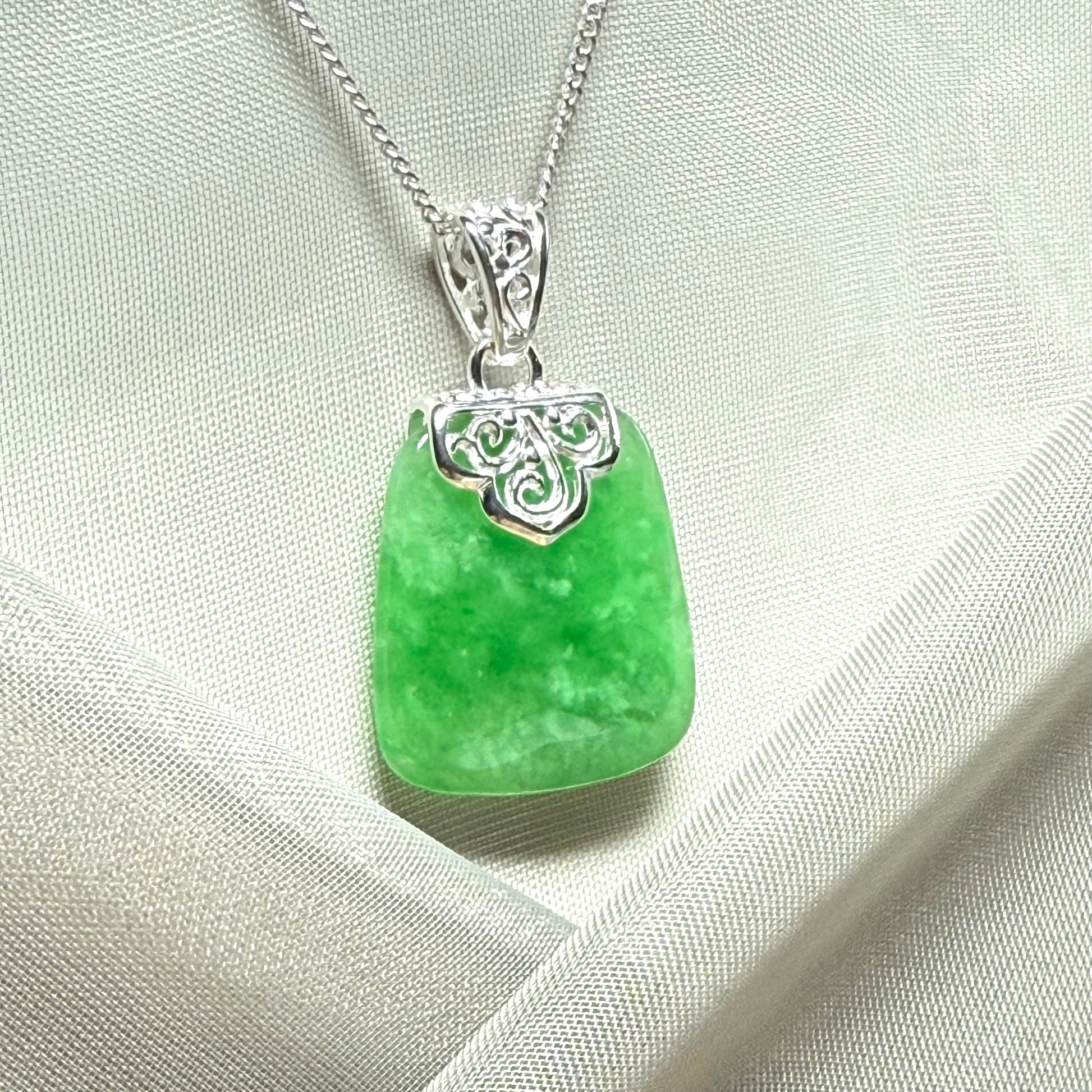 A beautiful and stunning real green jade necklace large pendant that is cushion shape