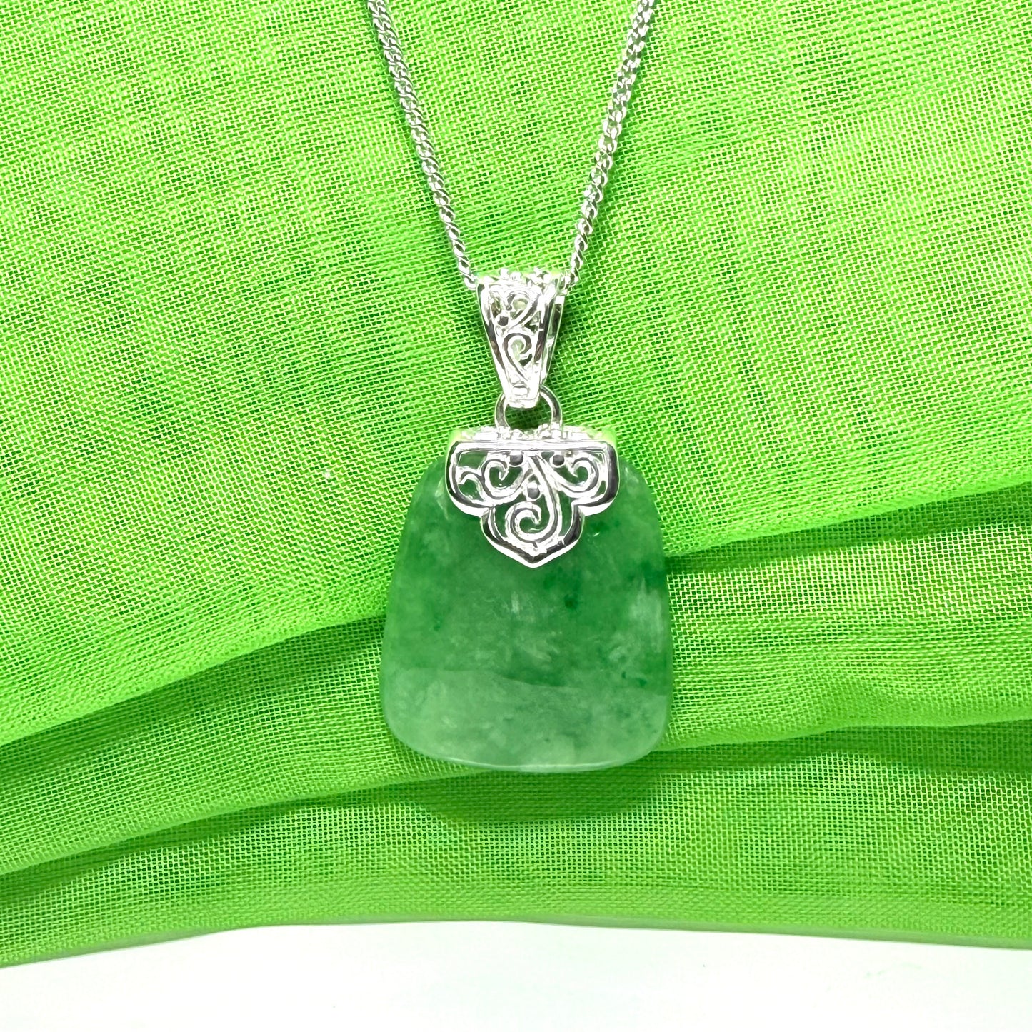 A beautiful and timeless real green jade necklace large cushion shaped with a chain included