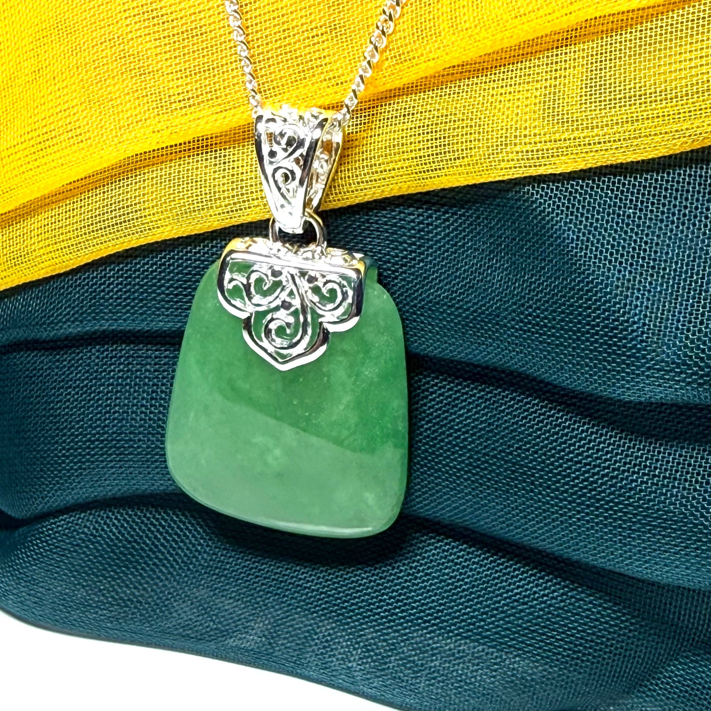 A beautiful and truly timeless real green jade necklace large pendant that is cushion shaped