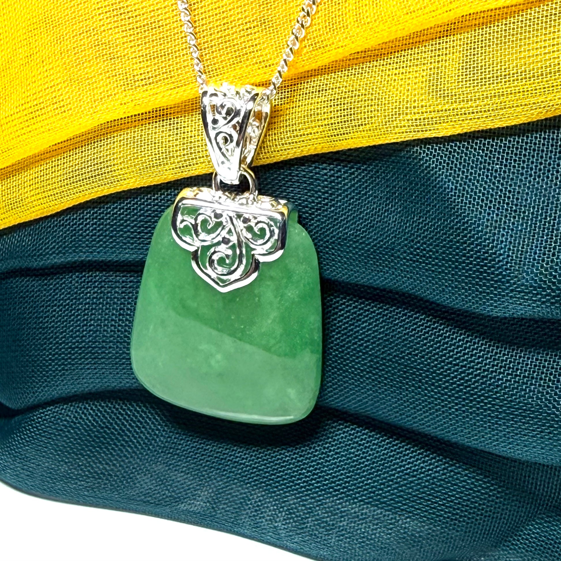 A beautiful and truly timeless real green jade necklace large pendant that is cushion shaped