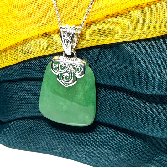A beautiful and truly timeless real green jade necklace large pendant that is cushion shaped