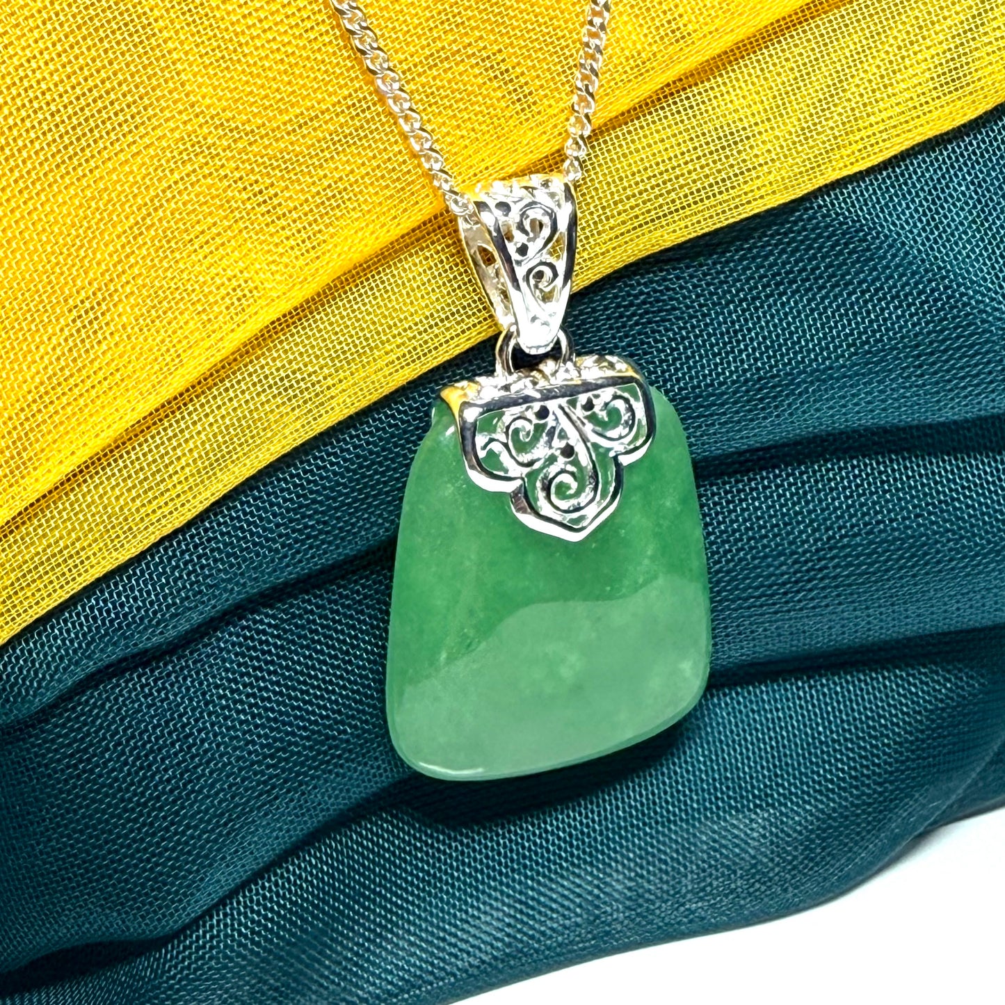 A beautiful and truly timeless real green jade necklace large pendant that is cushion shaped