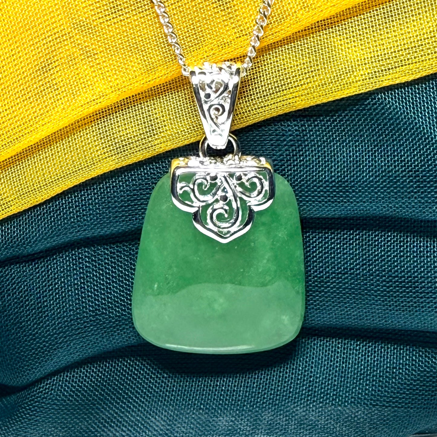 A beautiful and truly timeless real green jade necklace large pendant that is cushion shaped