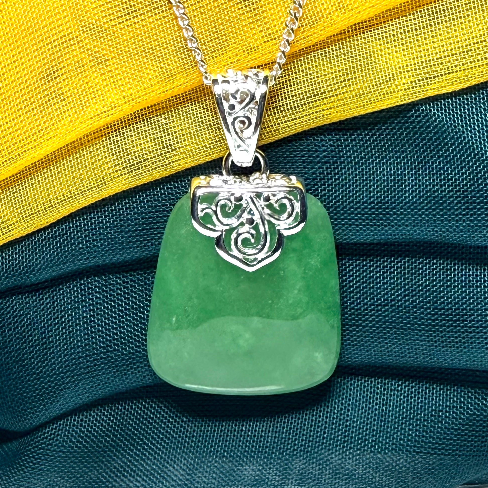 A beautiful and truly timeless real green jade necklace large pendant that is cushion shaped