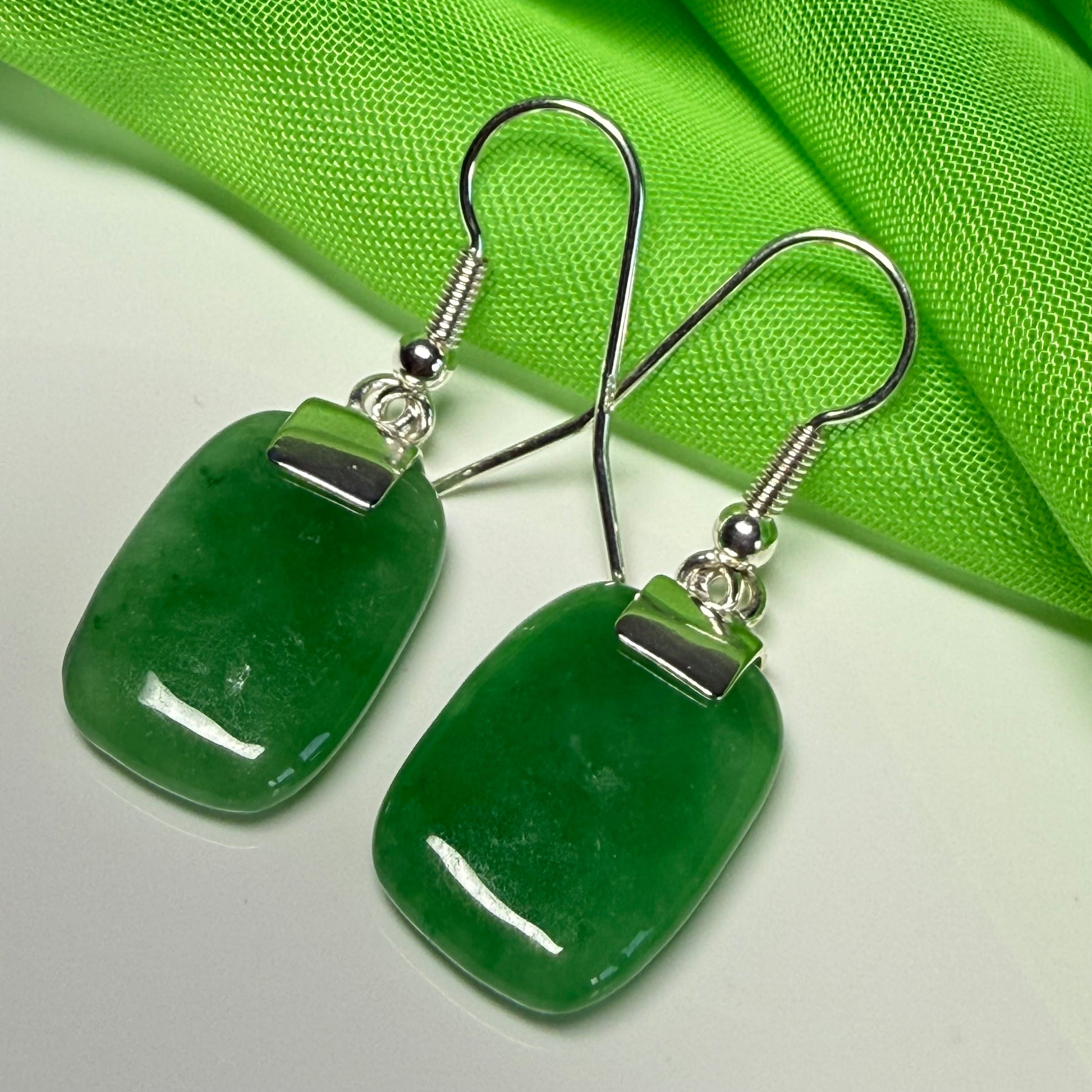 A beautiful pair of real green jade silver cushion shaped dropped earrings