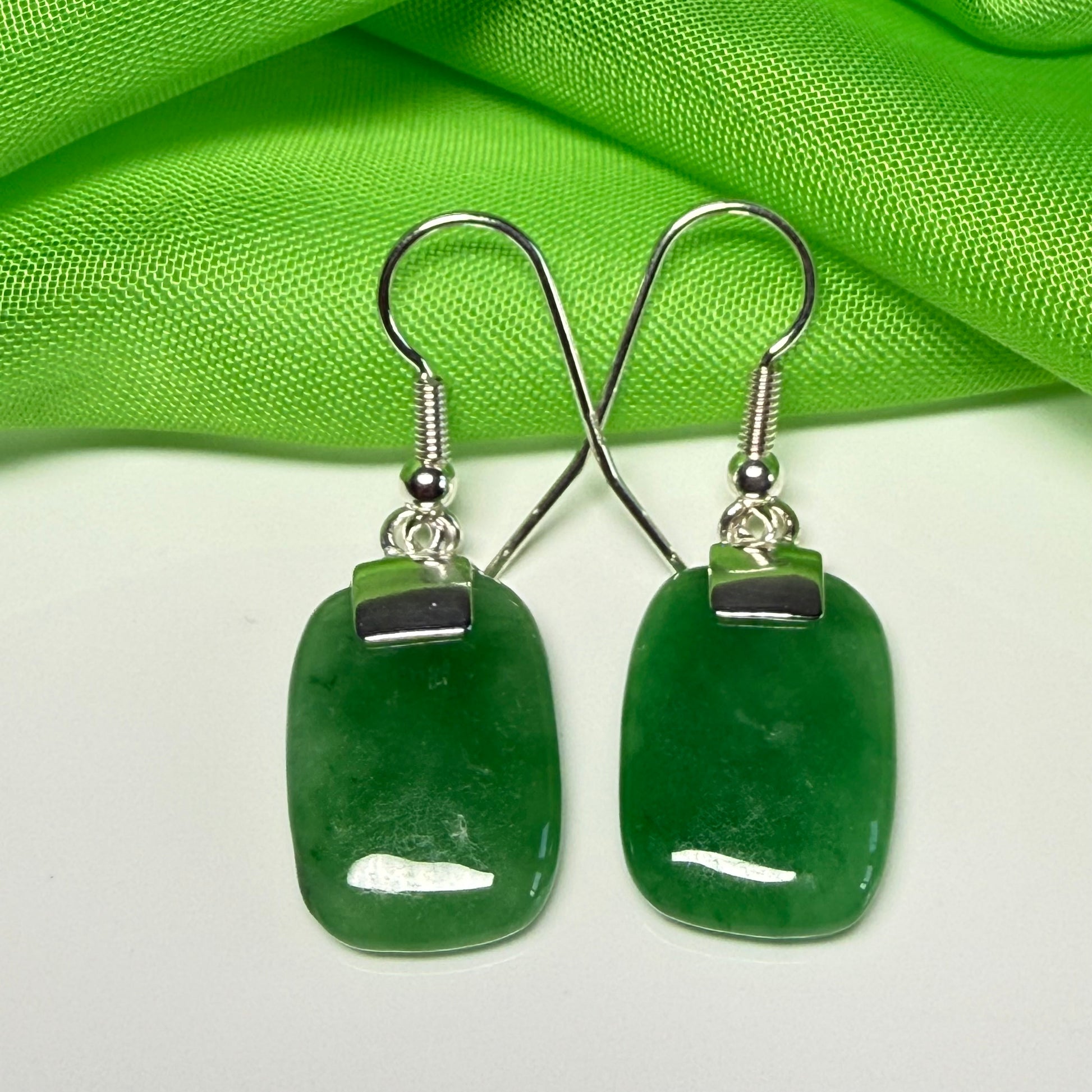 A beautiful pair of real green jade silver cushion shaped dropped earrings