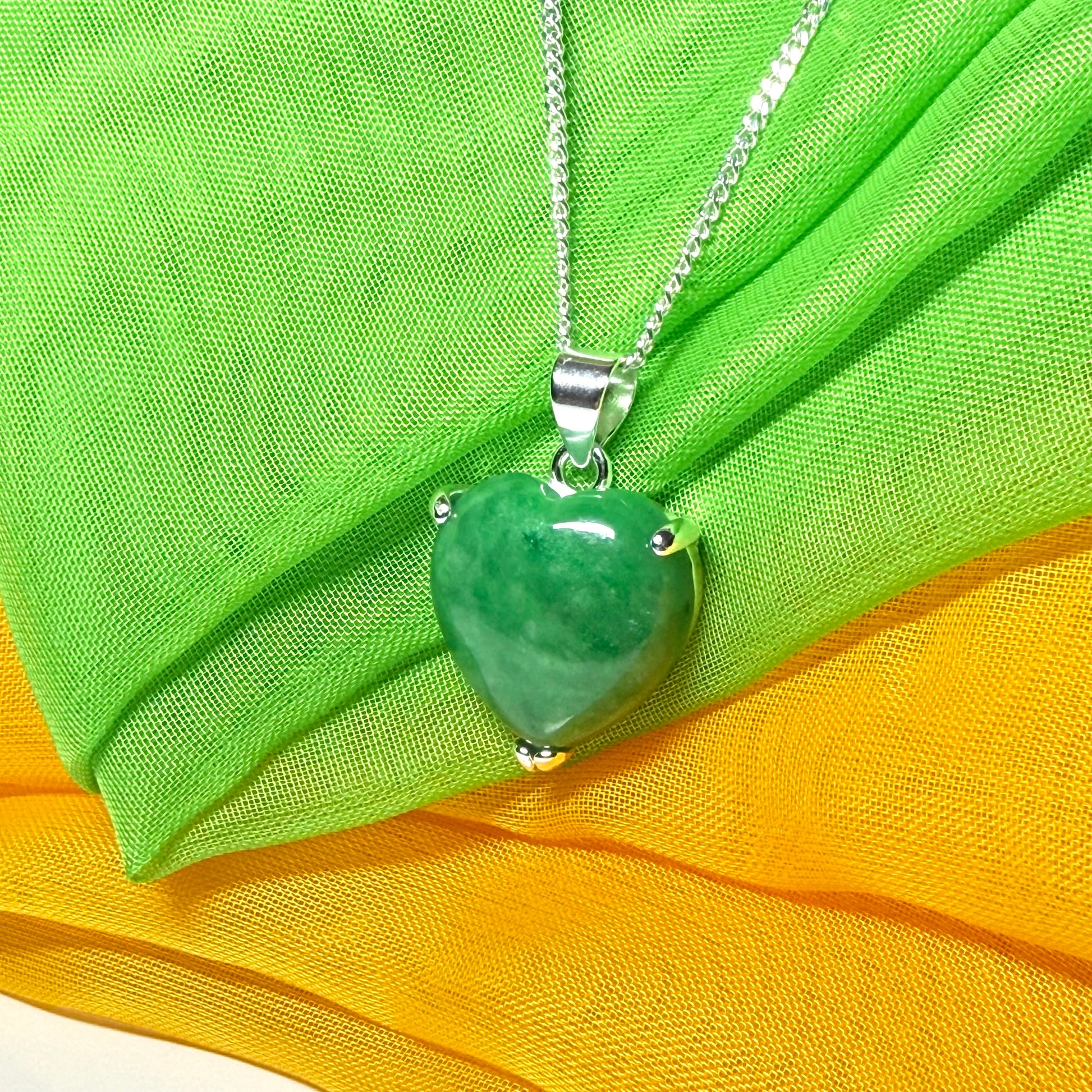 A beautiful real green jade necklace heart shape sterling silver pendant