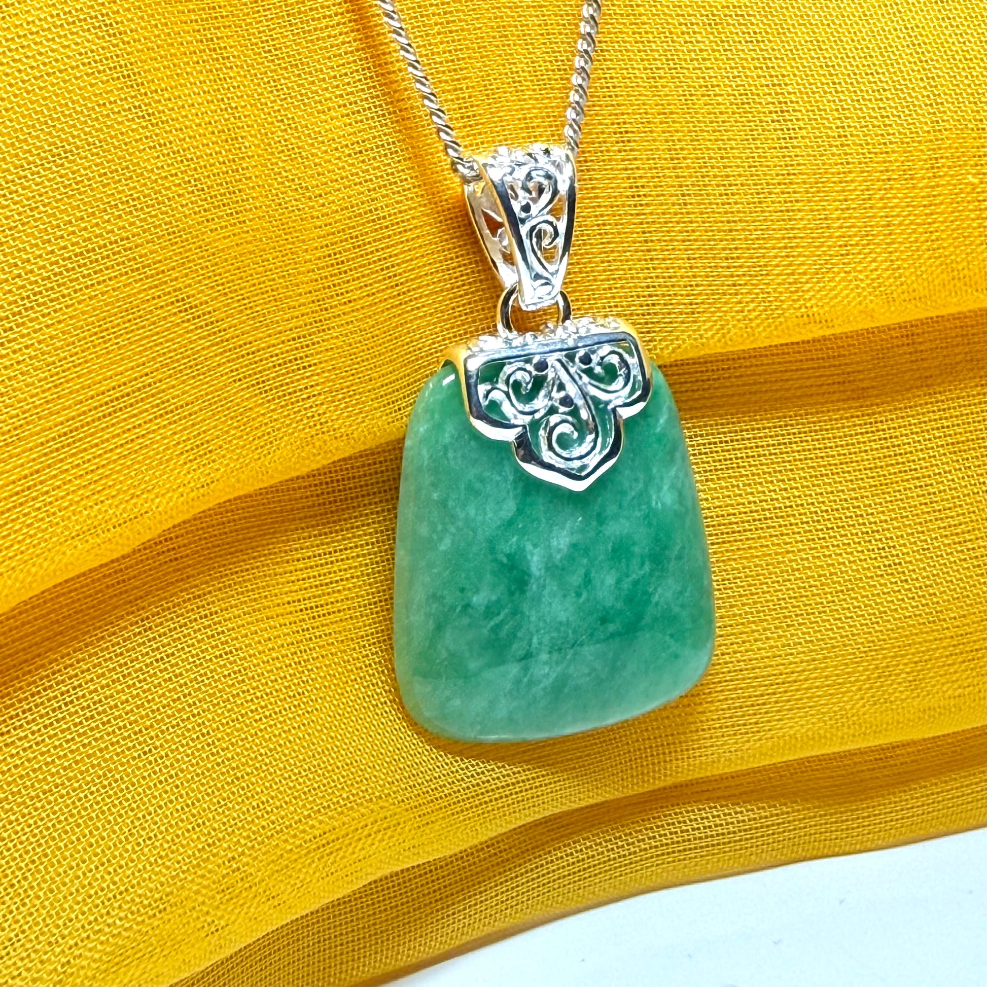 A beautiful real green jade necklace with a large shaped and patterned top pendant with chain