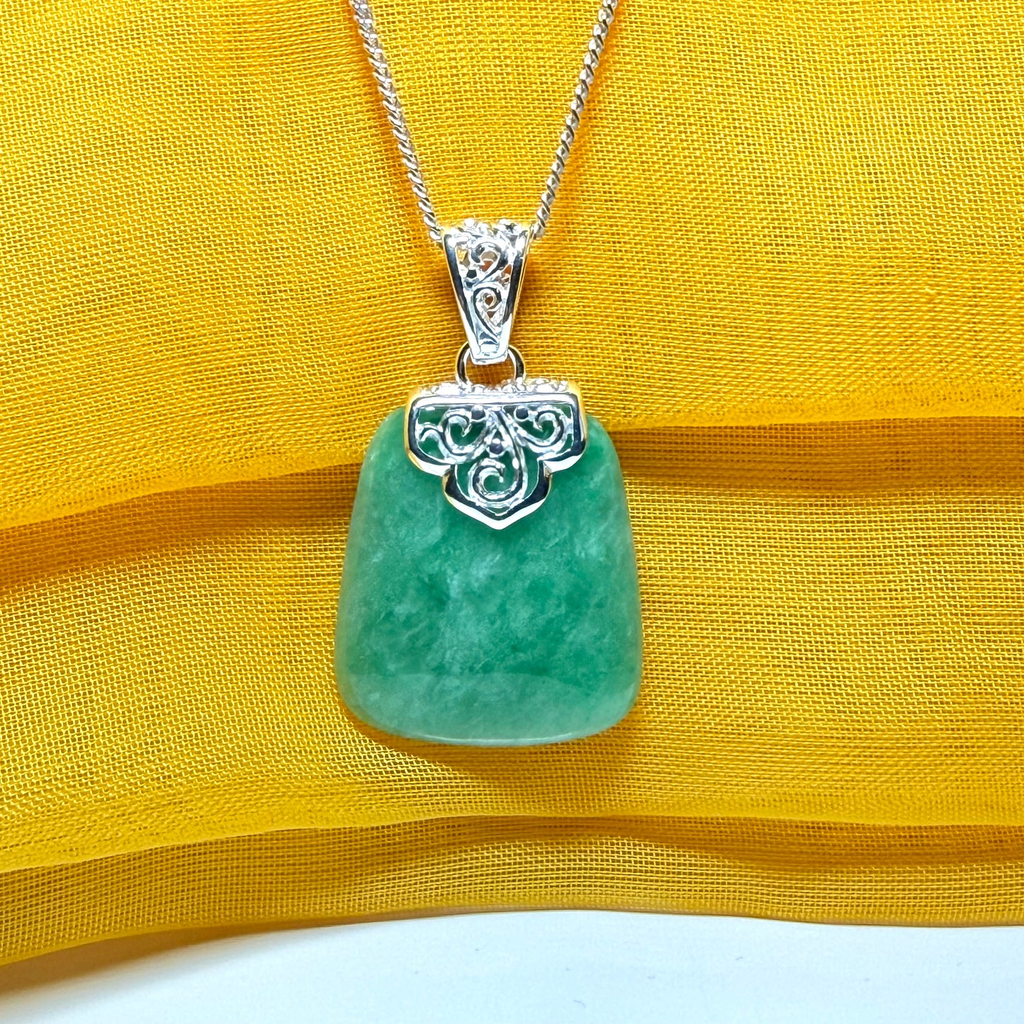 A beautiful real green jade necklace with a large shaped and patterned top pendant with chain
