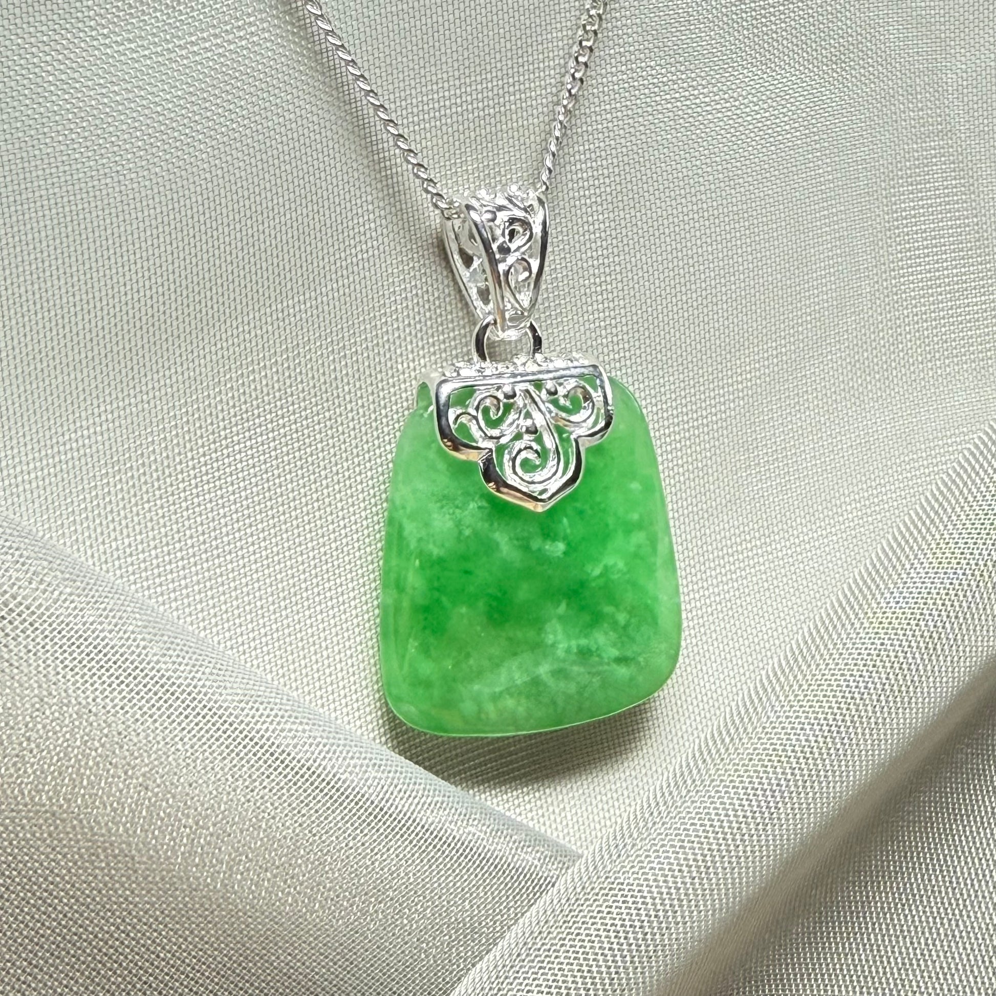 A beautiful and stunning real green jade necklace large pendant that is cushion shape