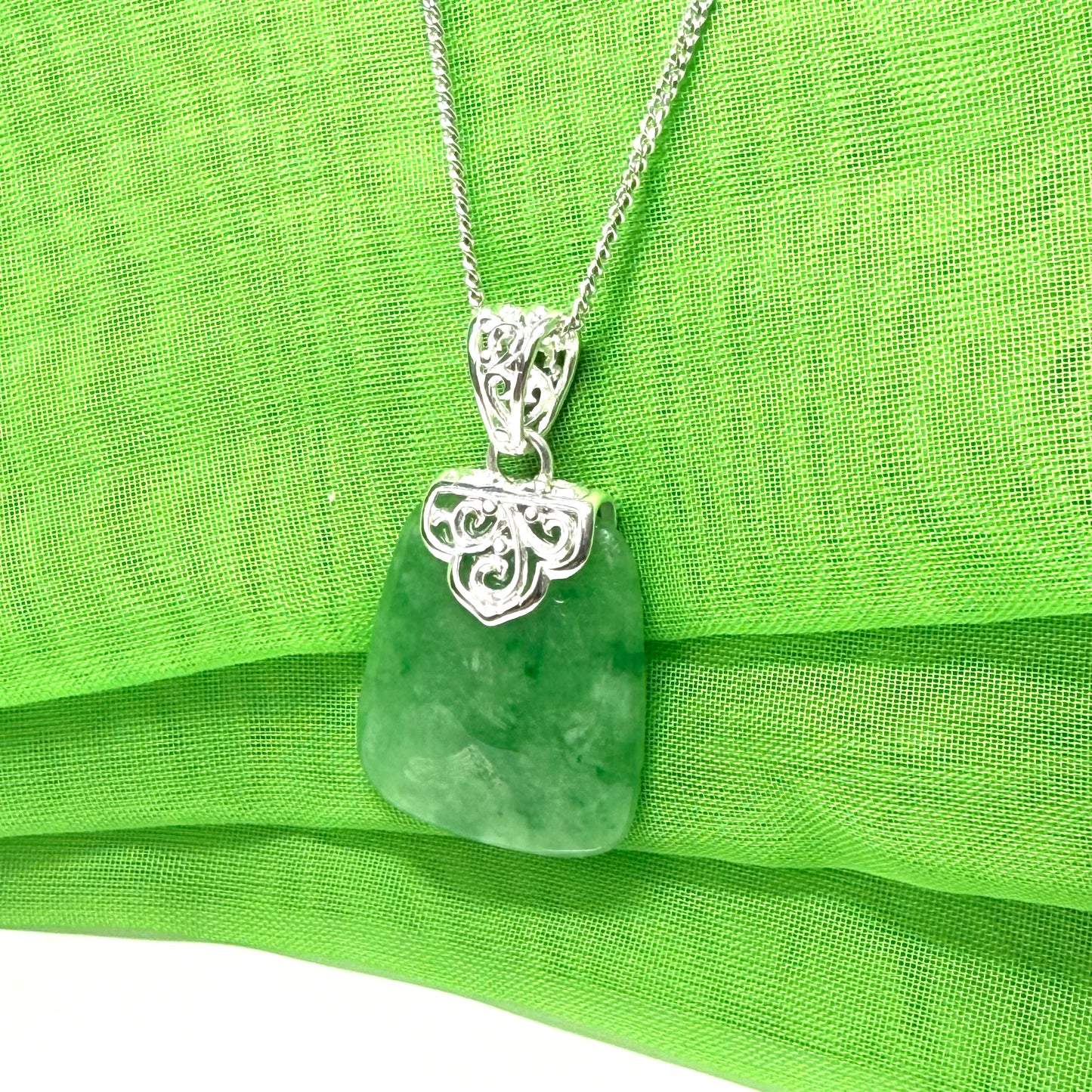 A beautiful and timeless real green jade necklace large cushion shaped with a chain included