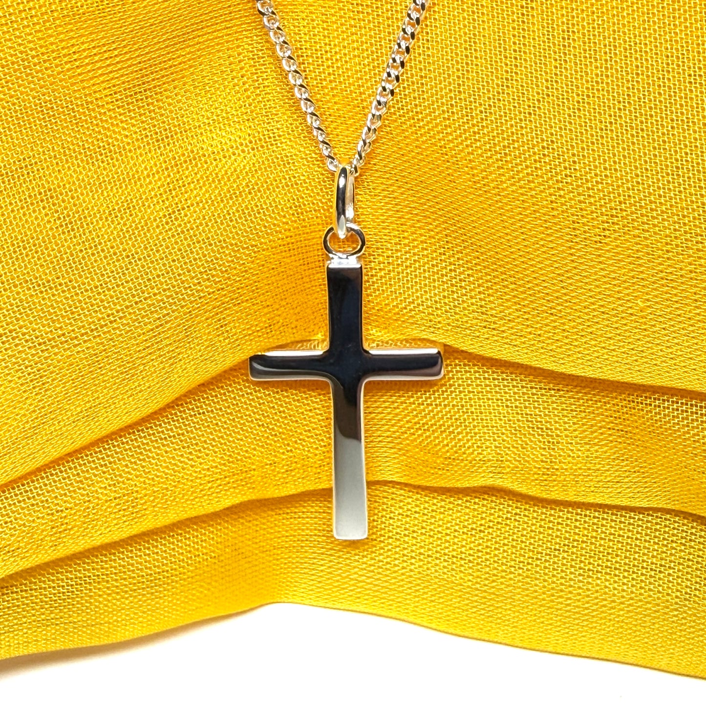 Cross and chain highly polished with an oval pendant loop on top of it chain included