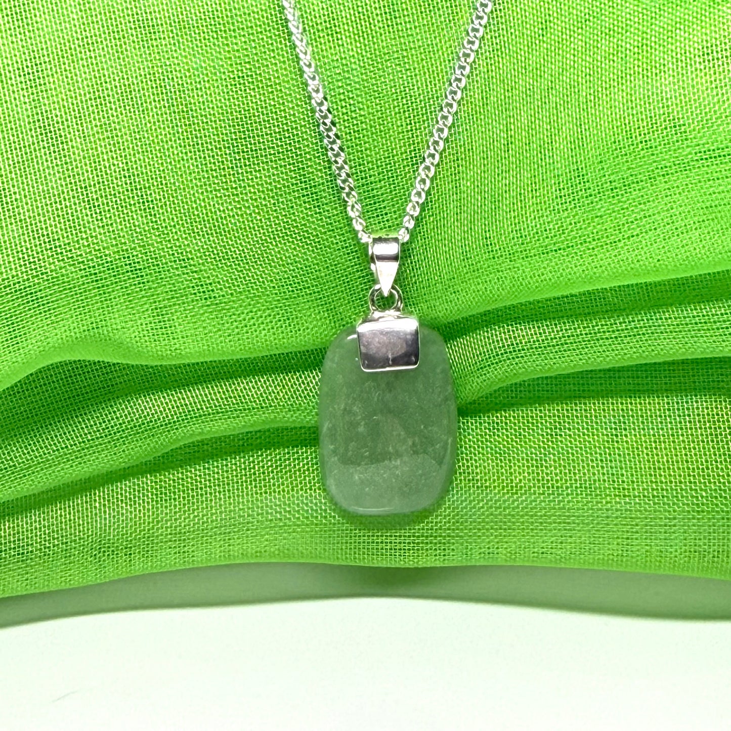 A cushion shaped silver real green jade necklace pendant