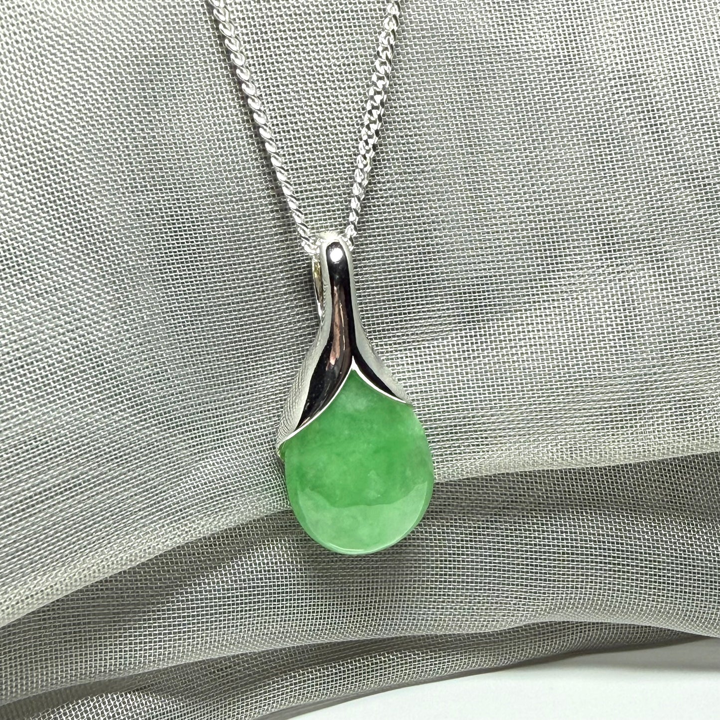 A gorgeous real green jade necklace teardrop with a pear shaped pendant to it