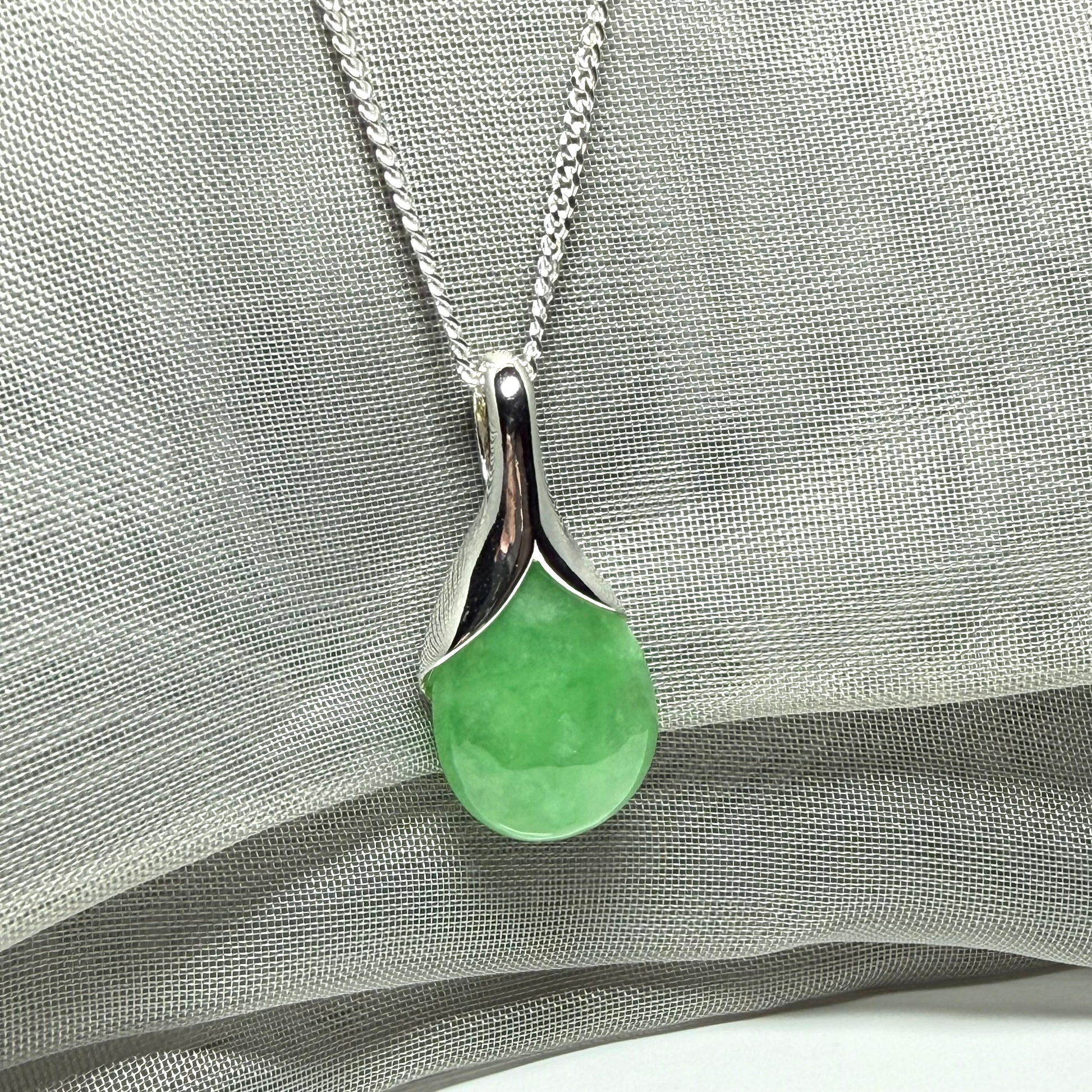 A gorgeous real green jade necklace teardrop with a pear shaped pendant to it