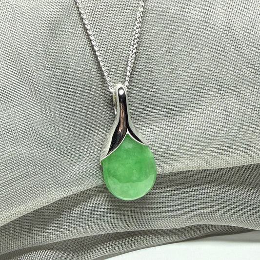 A gorgeous real green jade necklace teardrop with a pear shaped pendant to it