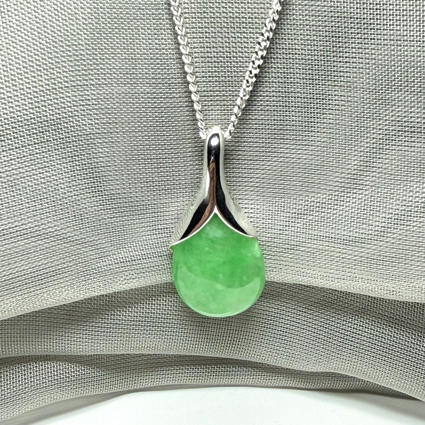 A gorgeous real green jade necklace teardrop with a pear shaped pendant to it