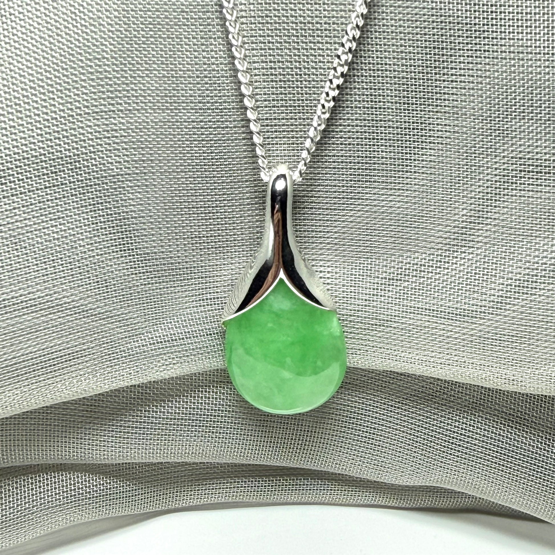 A gorgeous real green jade necklace teardrop with a pear shaped pendant to it