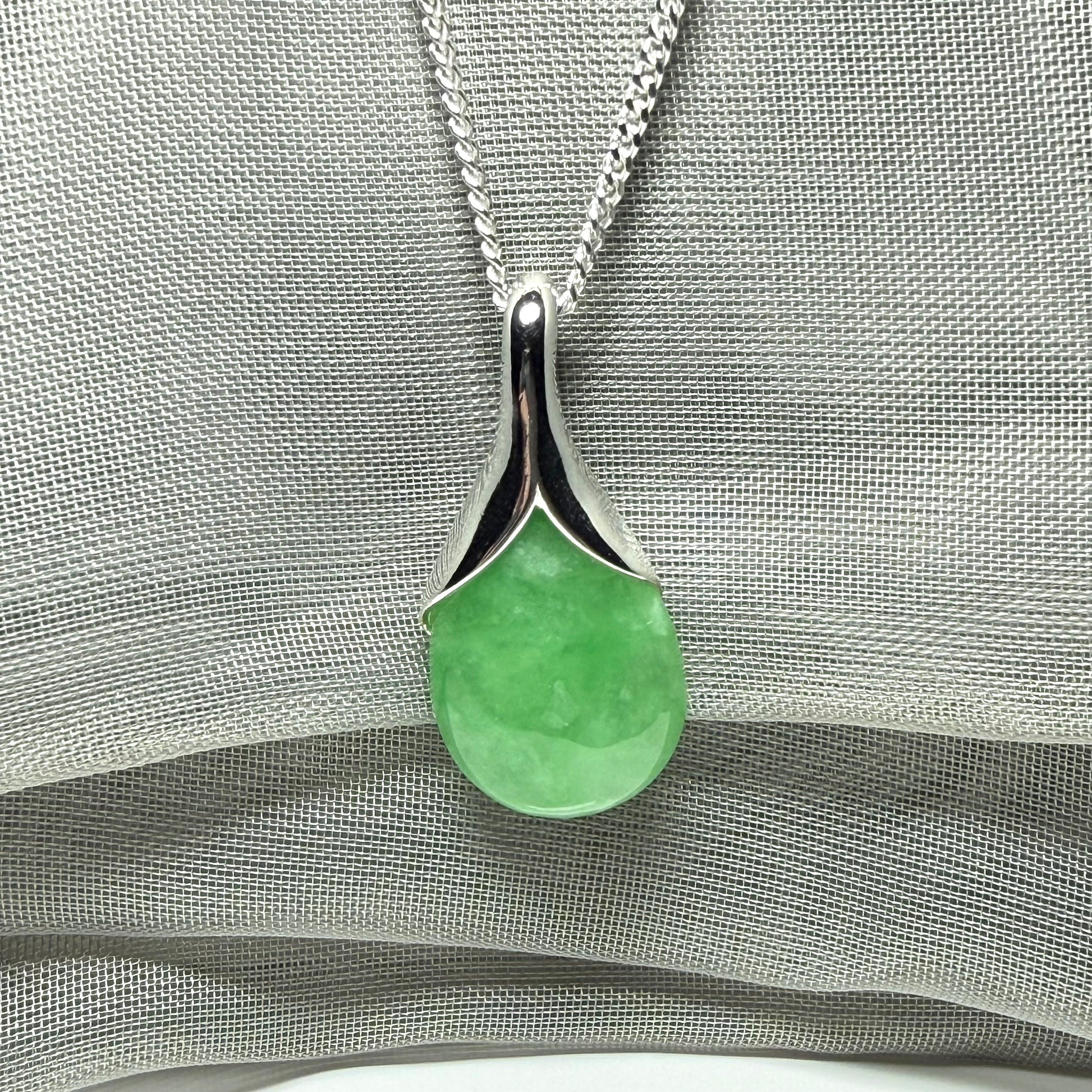 A gorgeous real green jade necklace teardrop with a pear shaped pendant to it