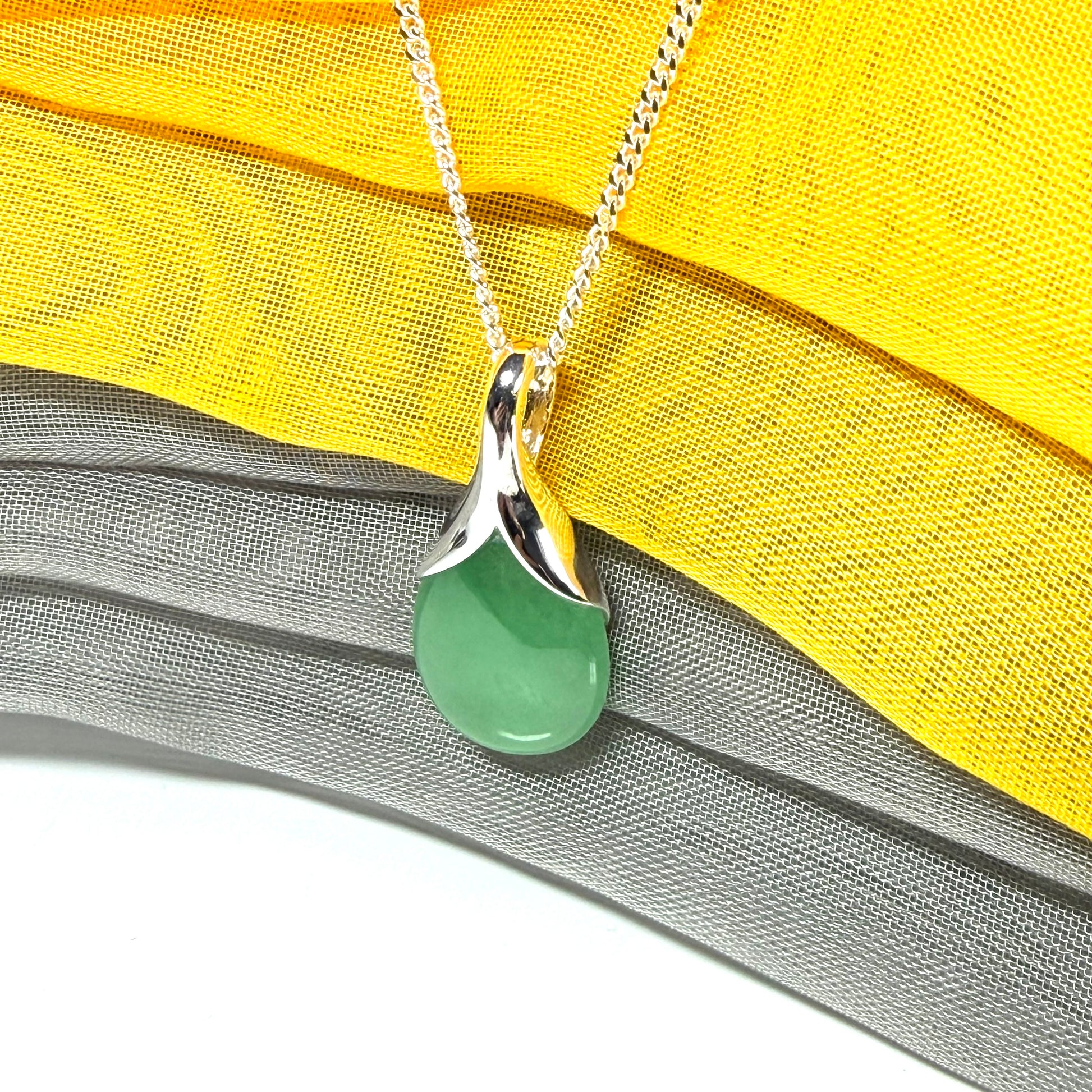 A gorgeous real green jade pendant in a teardrop or pear shape, a really meaningful designed necklace