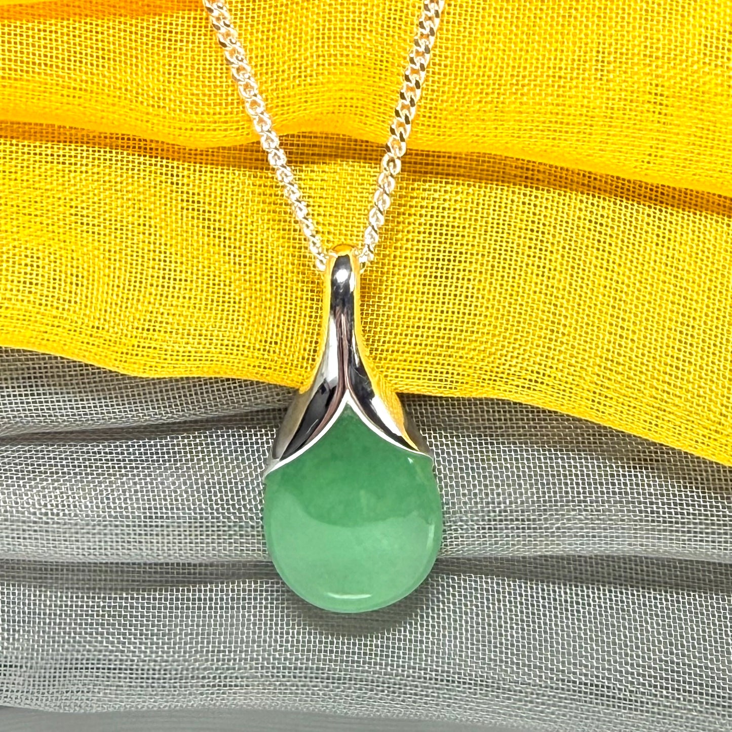 A gorgeous real green jade pendant in a teardrop or pear shape, a really meaningful designed necklace
