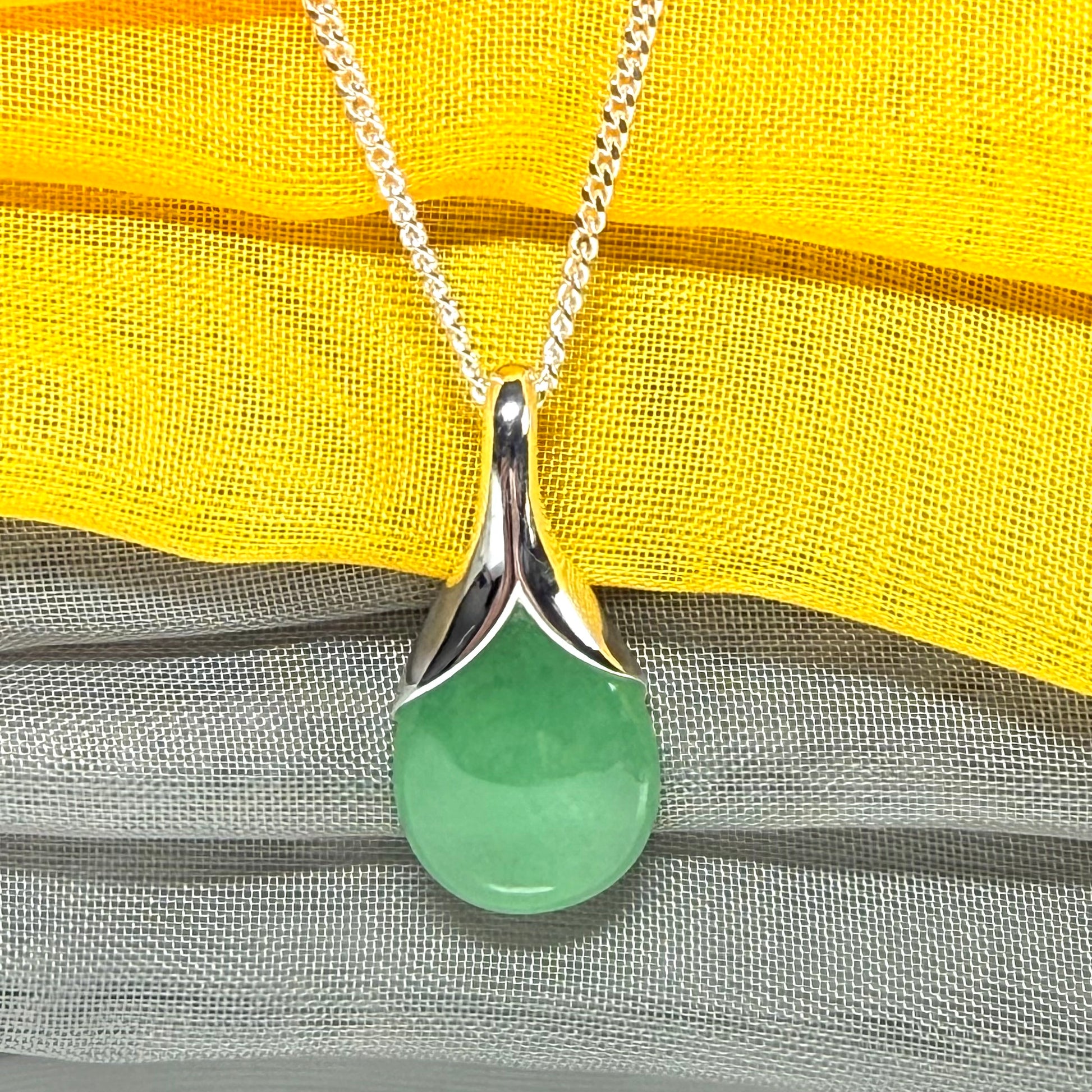 A gorgeous real green jade pendant in a teardrop or pear shape, a really meaningful designed necklace