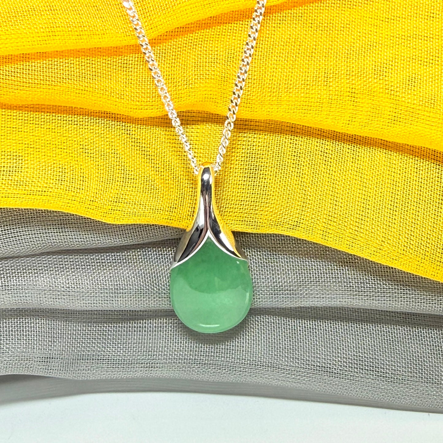 A gorgeous real green jade pendant in a teardrop or pear shape, a really meaningful designed necklace