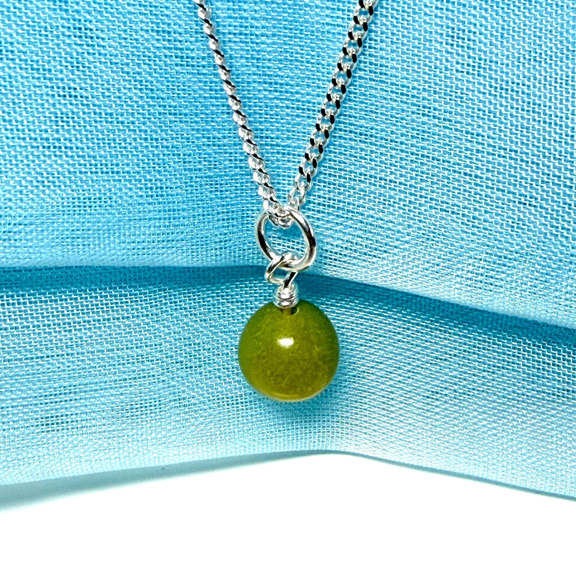 A gorgeous small real green gypsum necklace ball shaped, a really gorgeous round pendant with chain too