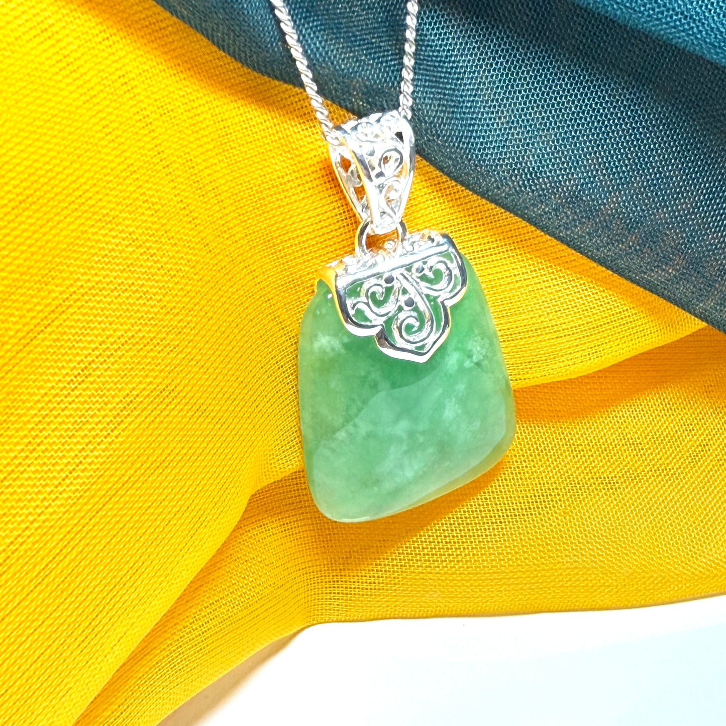 Green real jade necklace with a large shaped and patterned pendant