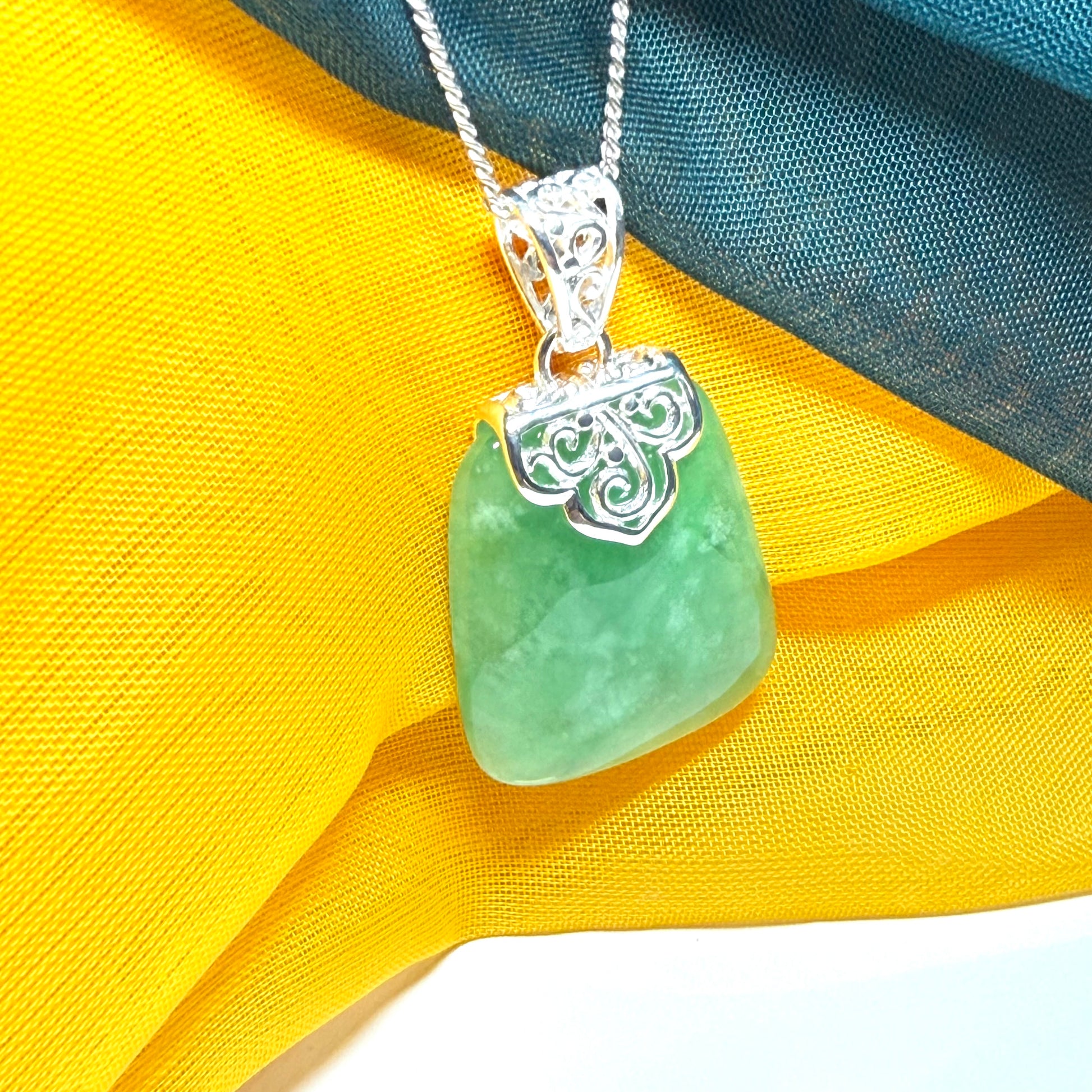 Green real jade necklace with a large shaped and patterned pendant