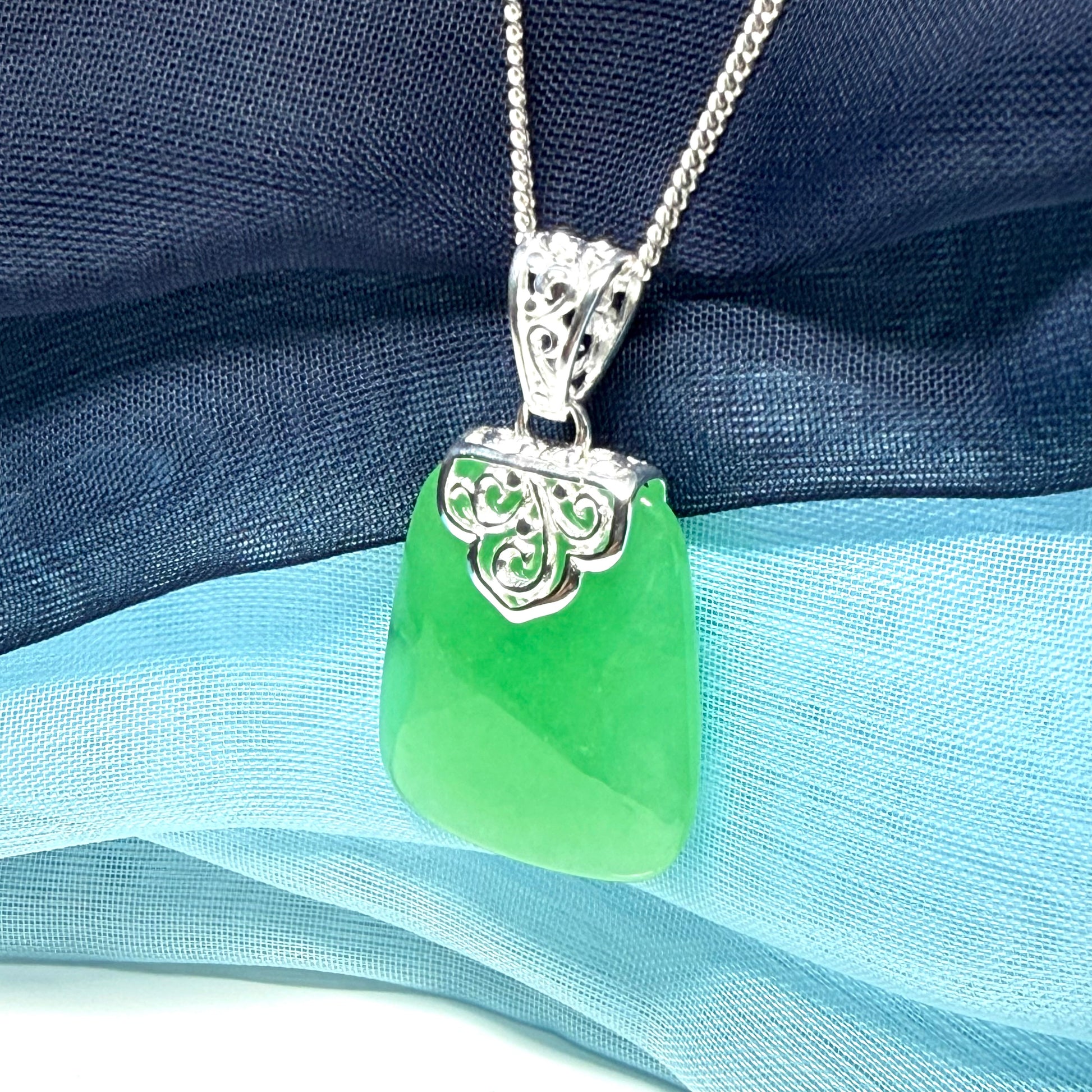Green real jade necklace with a large shaped and patterned pendant with chain