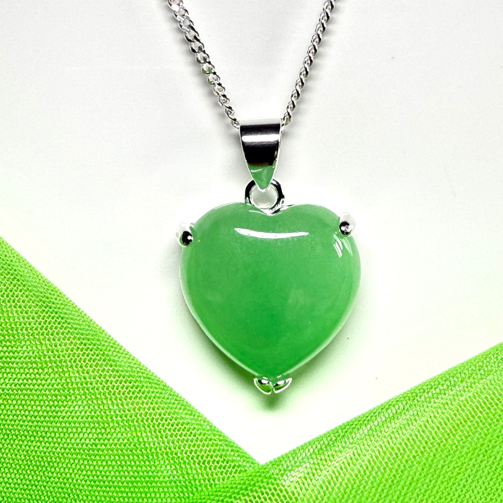 A green real jade pendant necklace heart shape sterling silver with a chain included