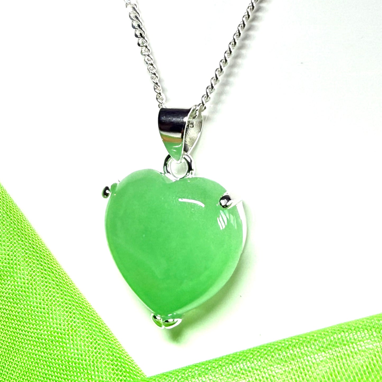 A green real jade pendant necklace heart shape sterling silver with a chain included
